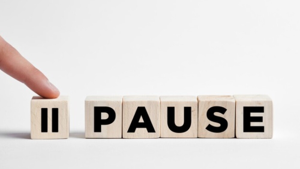 Pictured: Finger pressing pause button/iStock, cag