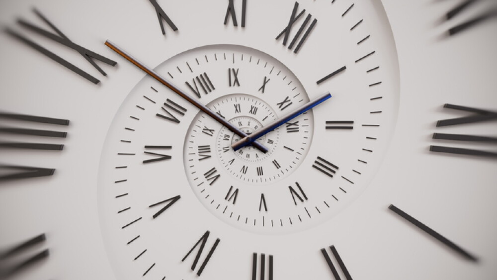 Vintage white spiral clock dial with roman numerals. Concept of Infinite time, deadline, scheduling, time and space, past, present and future.
