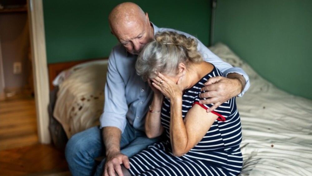 Pictured: Husband consoles agitated wife/