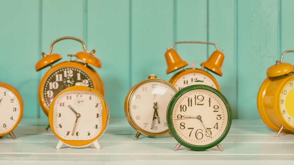 Retro styled image of a set of different colorful alarm clocks