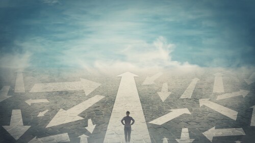 Doubtful person, hands on hips, choosing the way as multiple arrows on the road showing a mess of different directions. Choosing the correct pathway, difficult decision concept, confusion symbol.