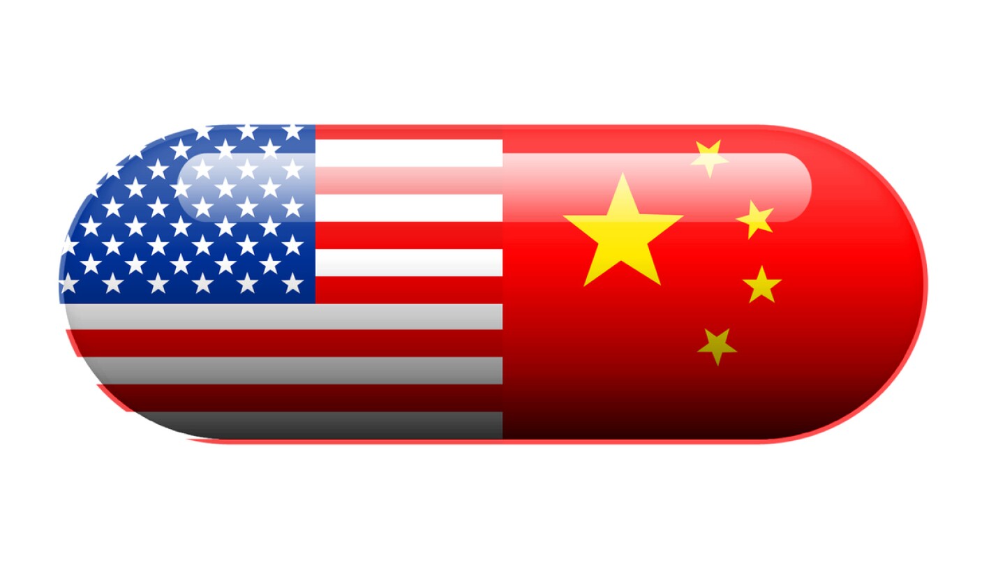 A pill with the Amercan and Chinese flag wrapped around it