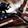 An illustration showing a cartoon man wearing a suit and holding a sledge hammer, standing on an abstract fractured American flag