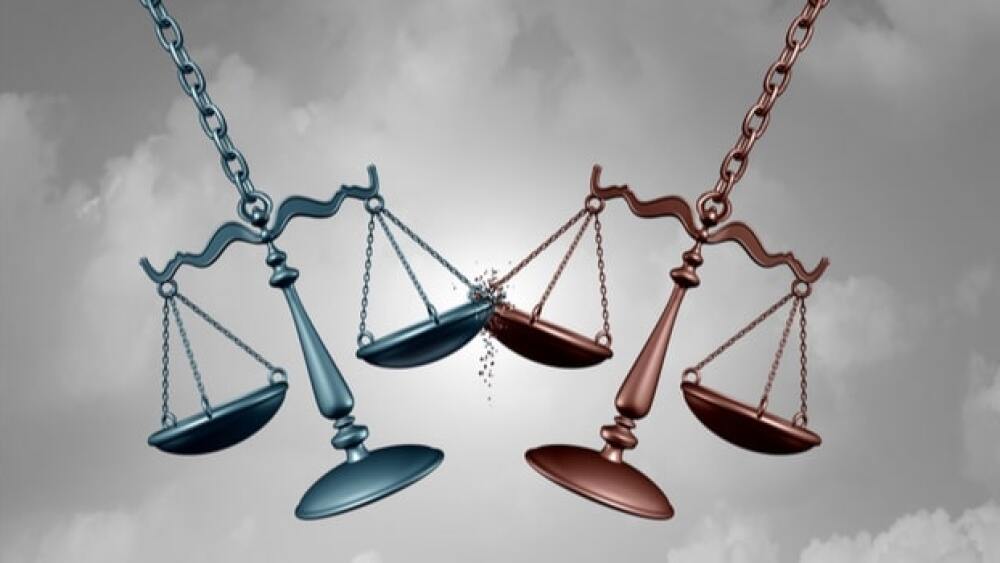 Scales of justice swing in the air/court