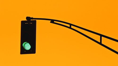 Traffic light silhouette and golden sky.