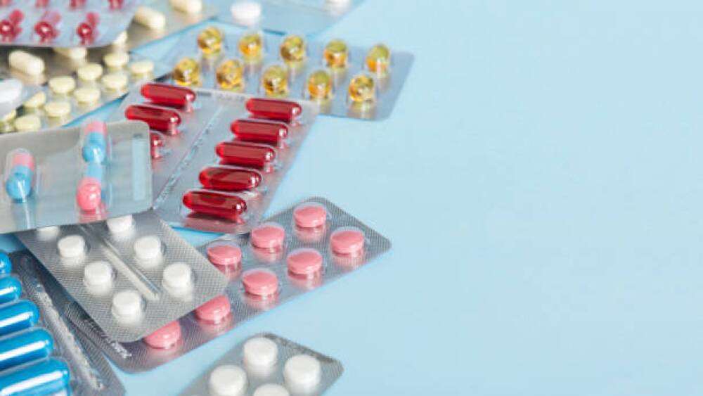 too many different pill of various blisters with different pills Medicines storage at home concept Medication storing. A pile of medicine in blister packs. Pharmaceutical blister packs.