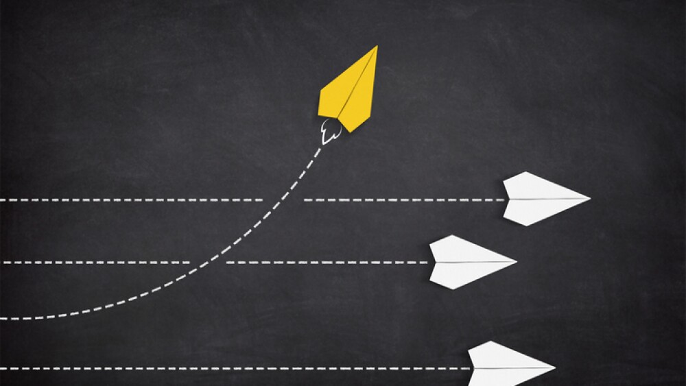 Yellow paper plane coming out from the advancing white paper planes. Change and different way concept.