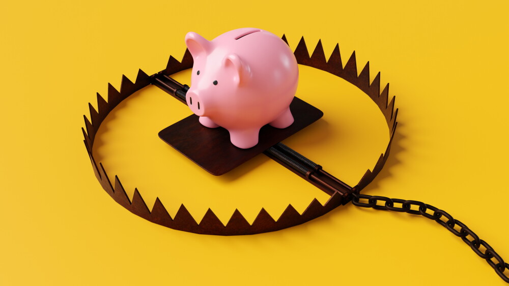 Pink piggy bank in a bear trap on yellow background. 3D illustration of the concept of personal fraud, online scams and money traps