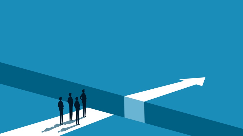 Illustration of businesspeople with forward progress stopped because of chasm between them and arrow pointing forward