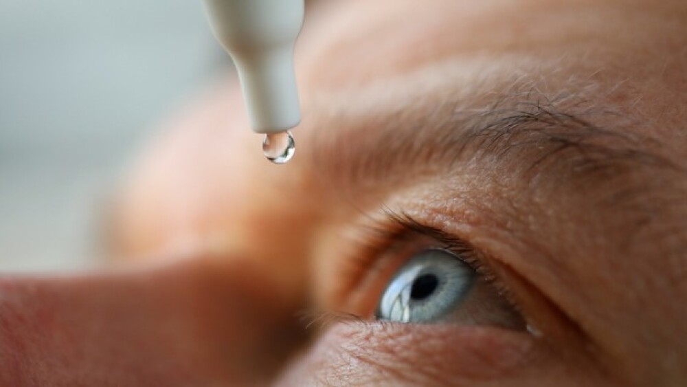 Pictured: Person applies eye drops/iStock, megaflo