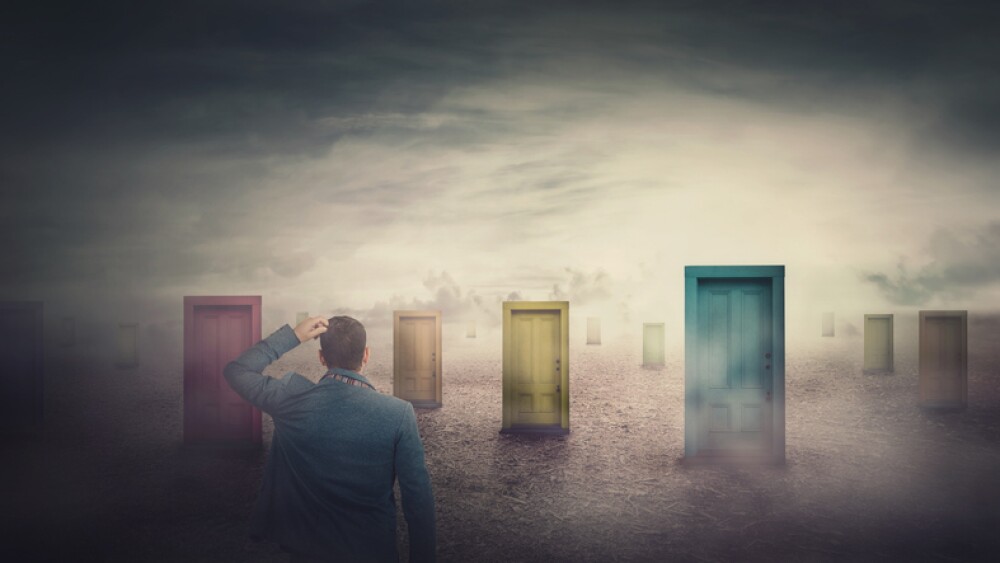 Rear view businessman in front of many different doors choosing one. Difficult decision, important choice, failure or success concept. Decisive ways to unknown future, business opportunity symbol.
