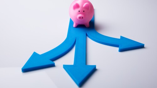 Elevated View Of Pink Piggybank And Blue Arrow Signs Showing Various Direction