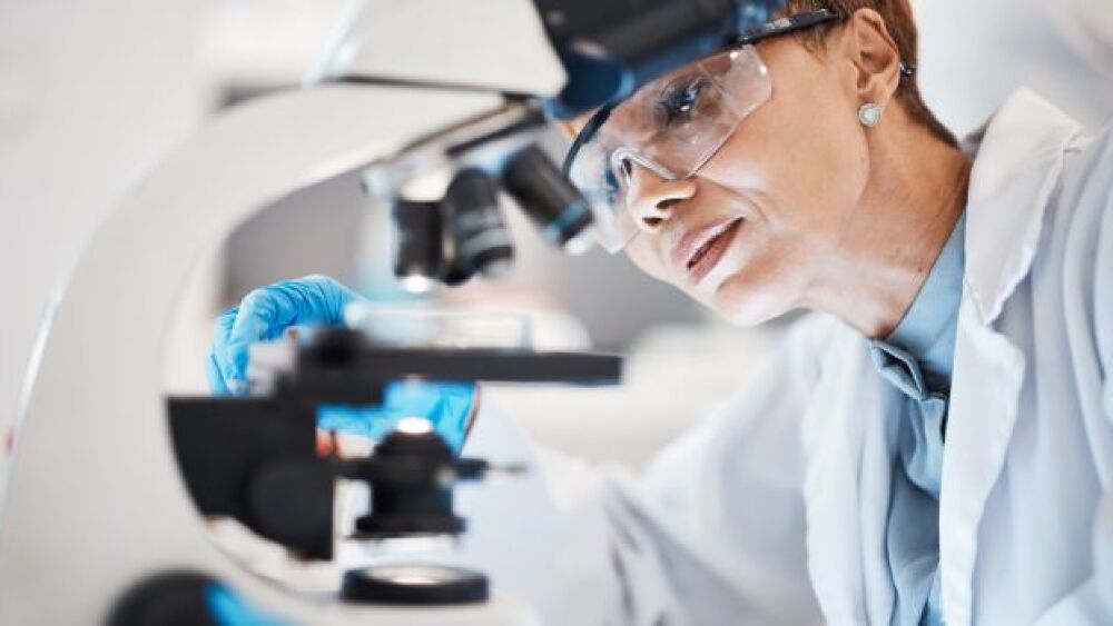 Pictured: Female scientist uses microscope for lab