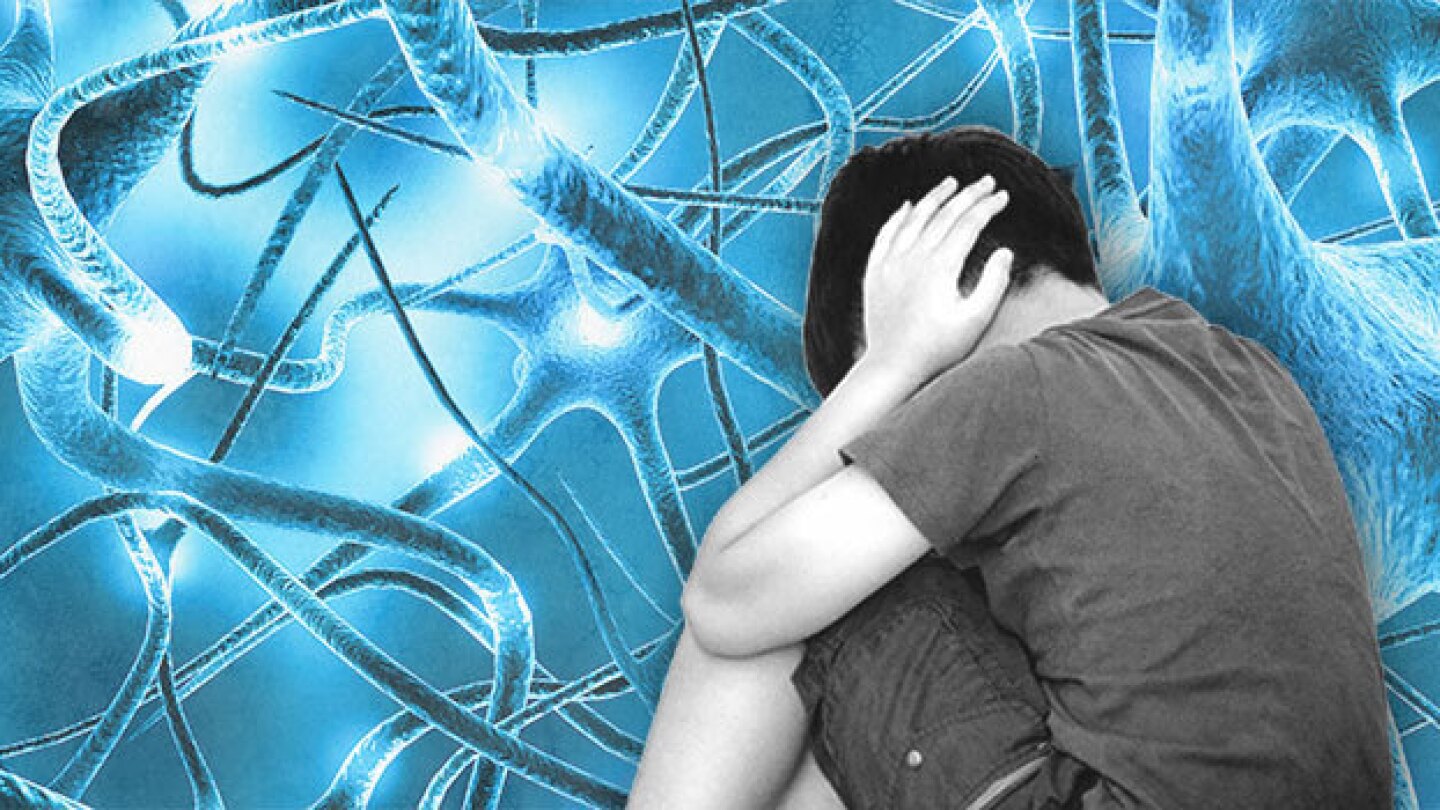 Pictured: A child covering his ears over a neuron