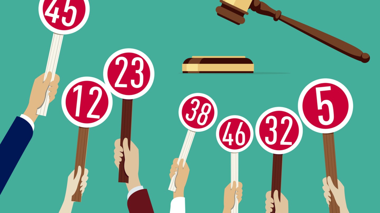 Auction concept: Hands holding paddle with numbers