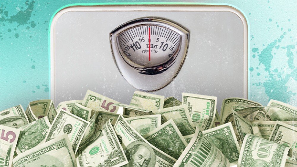 Weight loss scale and pile of money