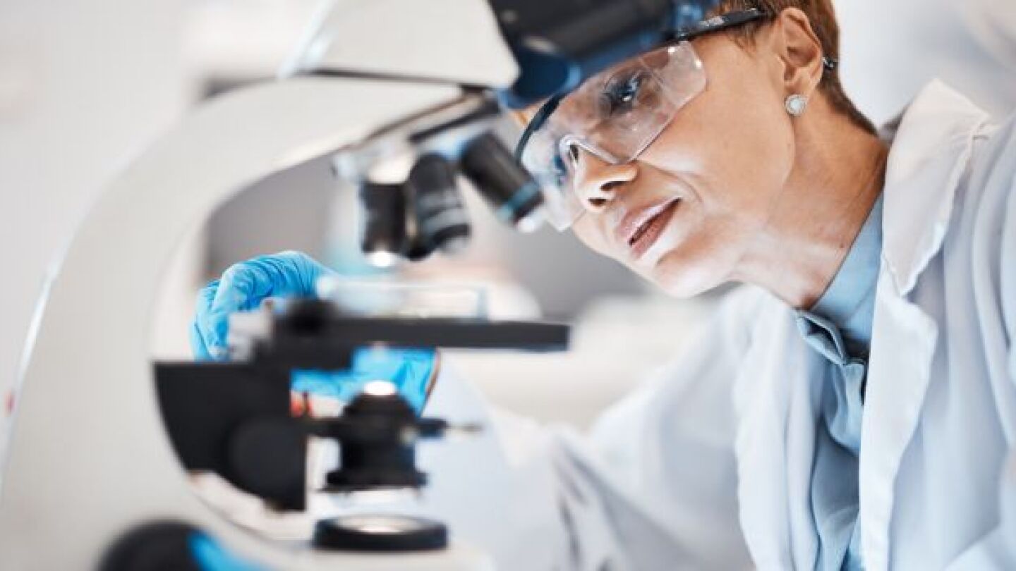 Pictured: Female scientist uses microscope for lab