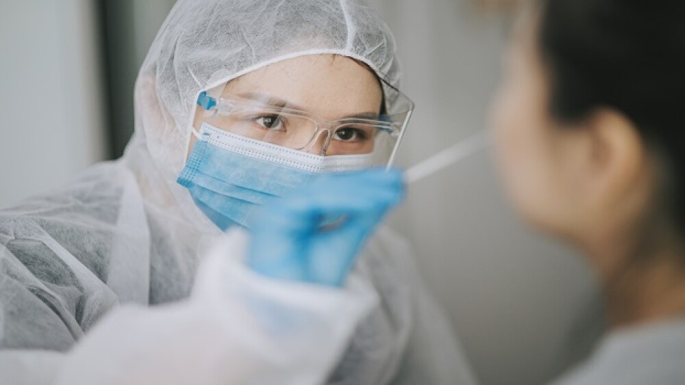 Pictured: Medical professional giving COVID Test/C
