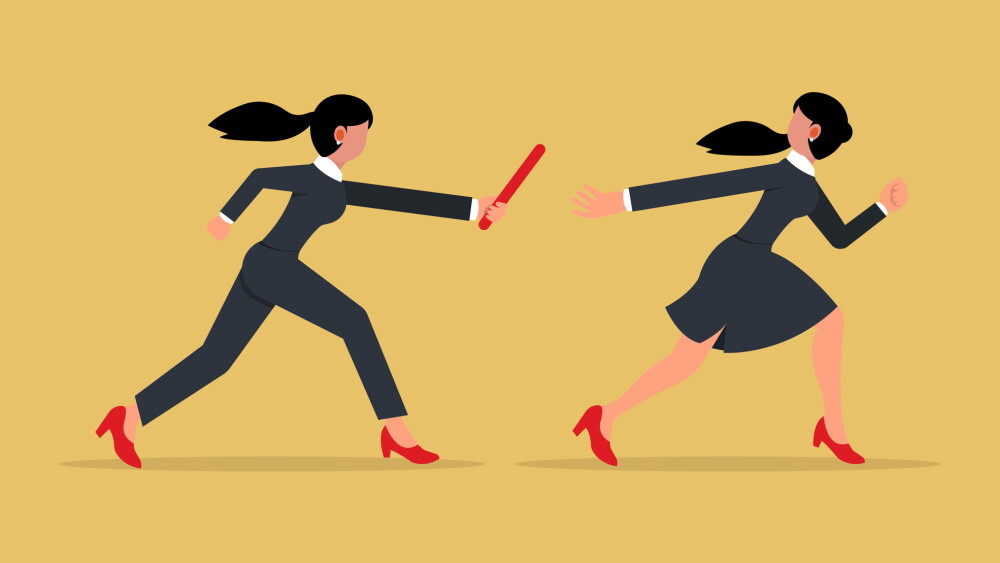 Teamwork concept. Two businesswomen passed from hand to hand relay baton.