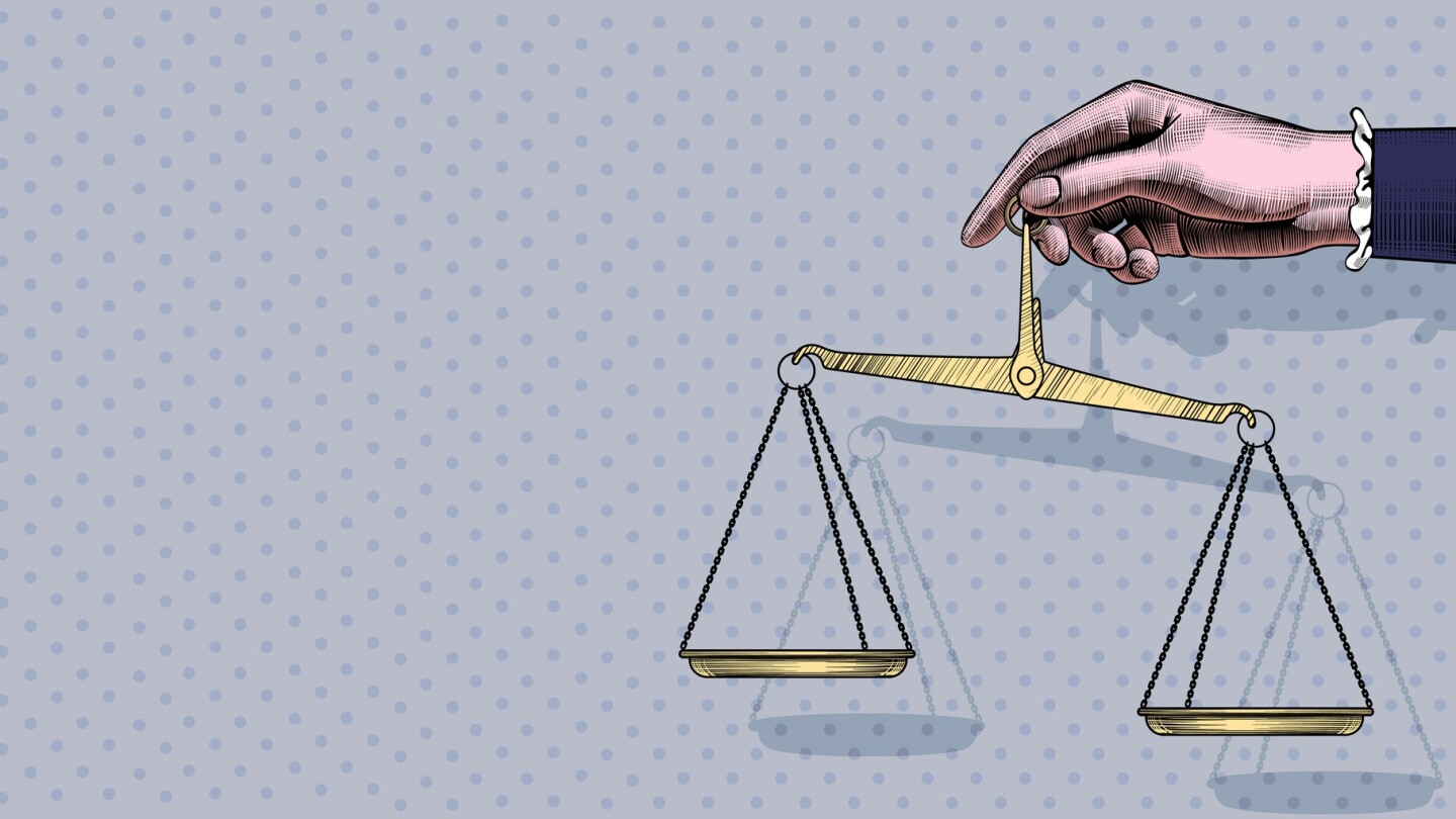 A woman's hand holding a scale.