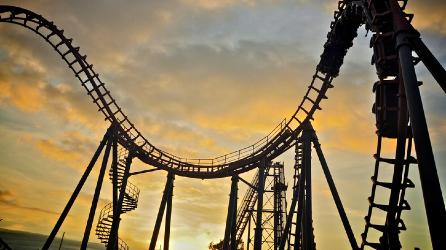 Roller coaster on sunset sky.