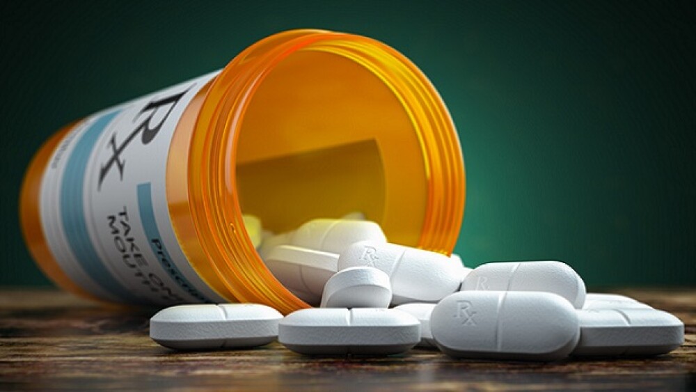 Pictured: Pills spilling out from a yellow contain