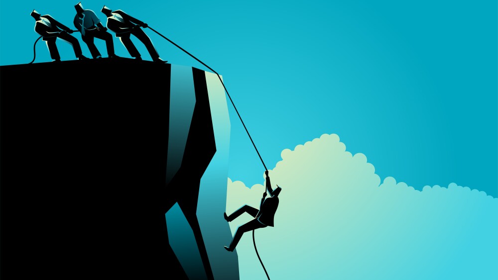 Businessmen helping their friend climbing the rock, teamwork, partnership in business concept