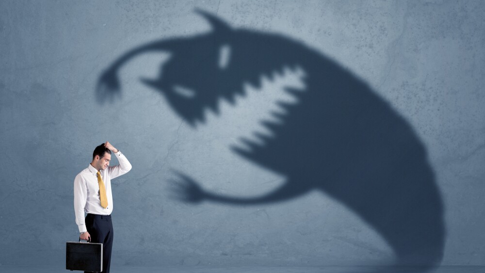 Business man afraid of his own shadow monster concept on grungy background