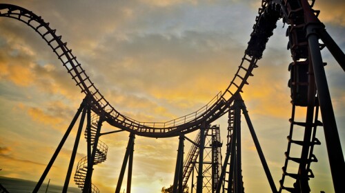 Roller coaster on sunset sky.