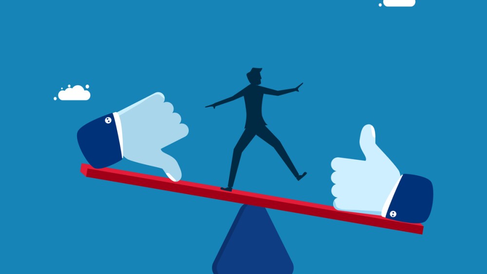 Businessman balancing on seesaw with thumb up and thumb down