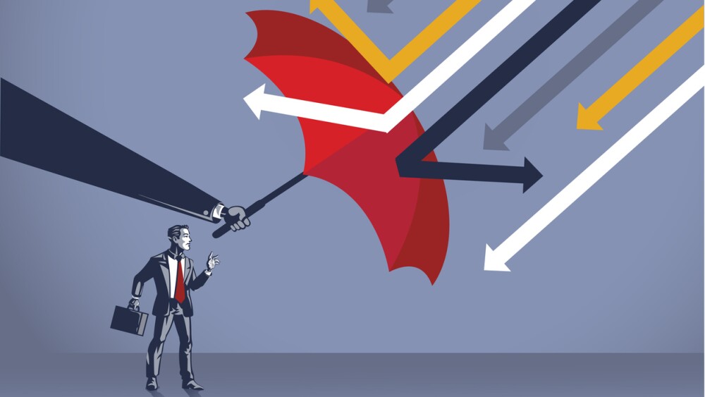 Powerful hand protects businessman from attacking arrow with umbrella blue collar 