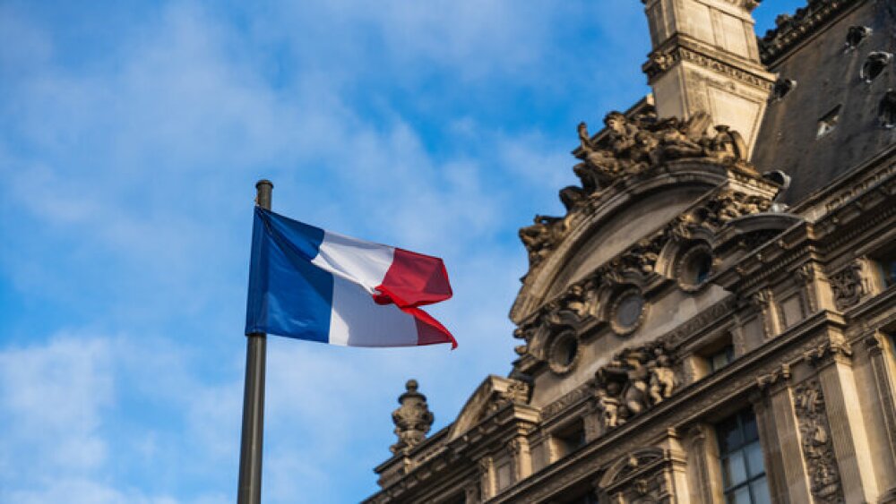 Pictured: French flag in front of a historical building