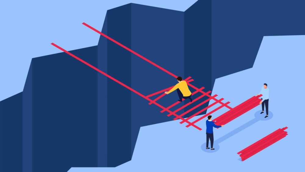 cartoon showing teamwork to build a bridge across a chasm