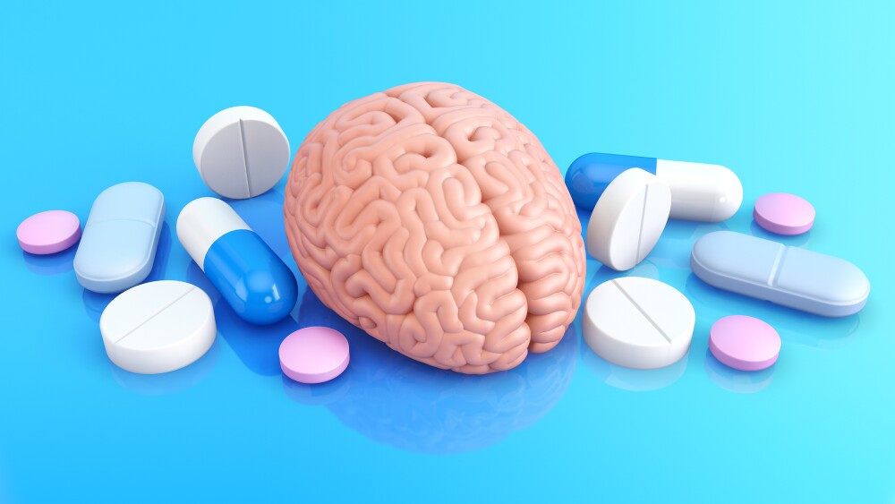 Model of human brain and pills to improve memory. 3D illustration.