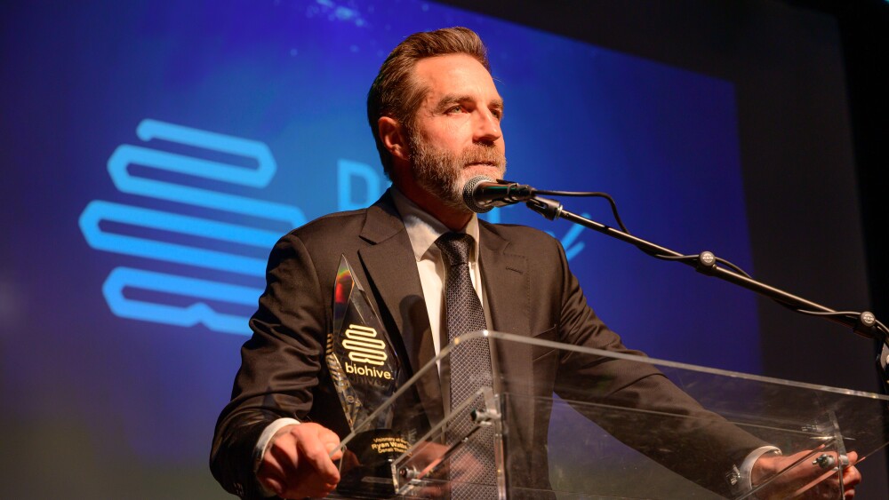 Denali Therapeutic CEO Ryan Watts accepts the Visionary of the Year award at BioHive Live in Salt Lake City, Utah, on April 16, 2026.