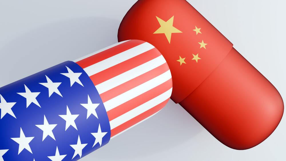 a 3D rendering of a capsule-shaped pill showcases the flag of United State of America and flag of China