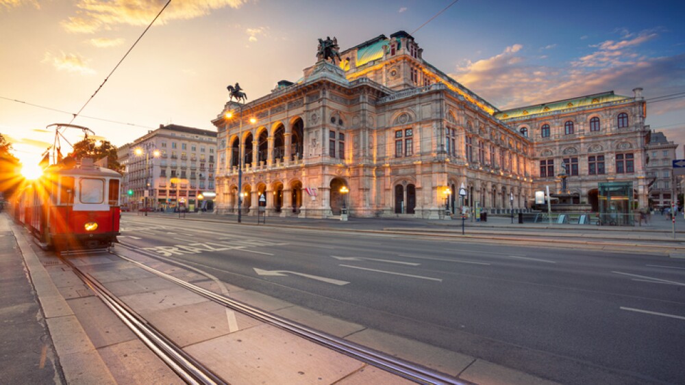 Cityscape image of Vienna with the Vienna State Opera during sunset.