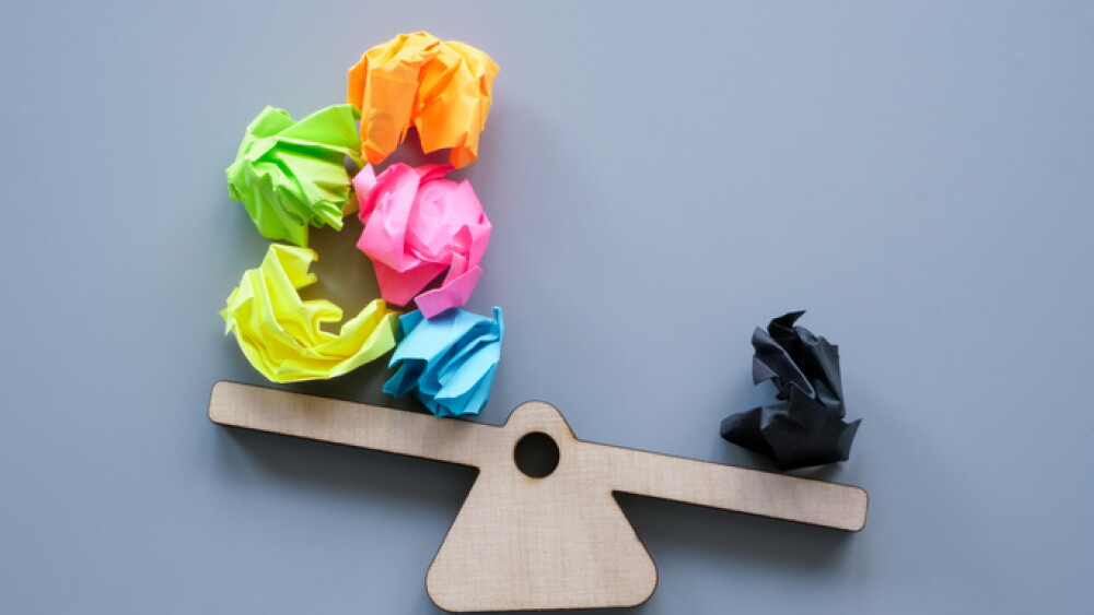 Scales and paper balls as a symbol of positive and negative thoughts.