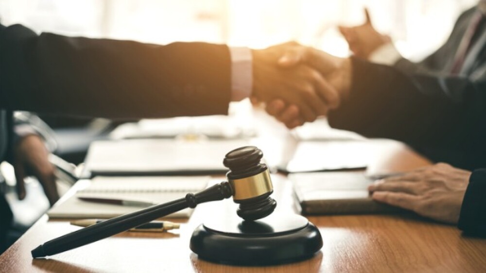 Pictured: Businessmen shaking hands/iStock, AmnajK