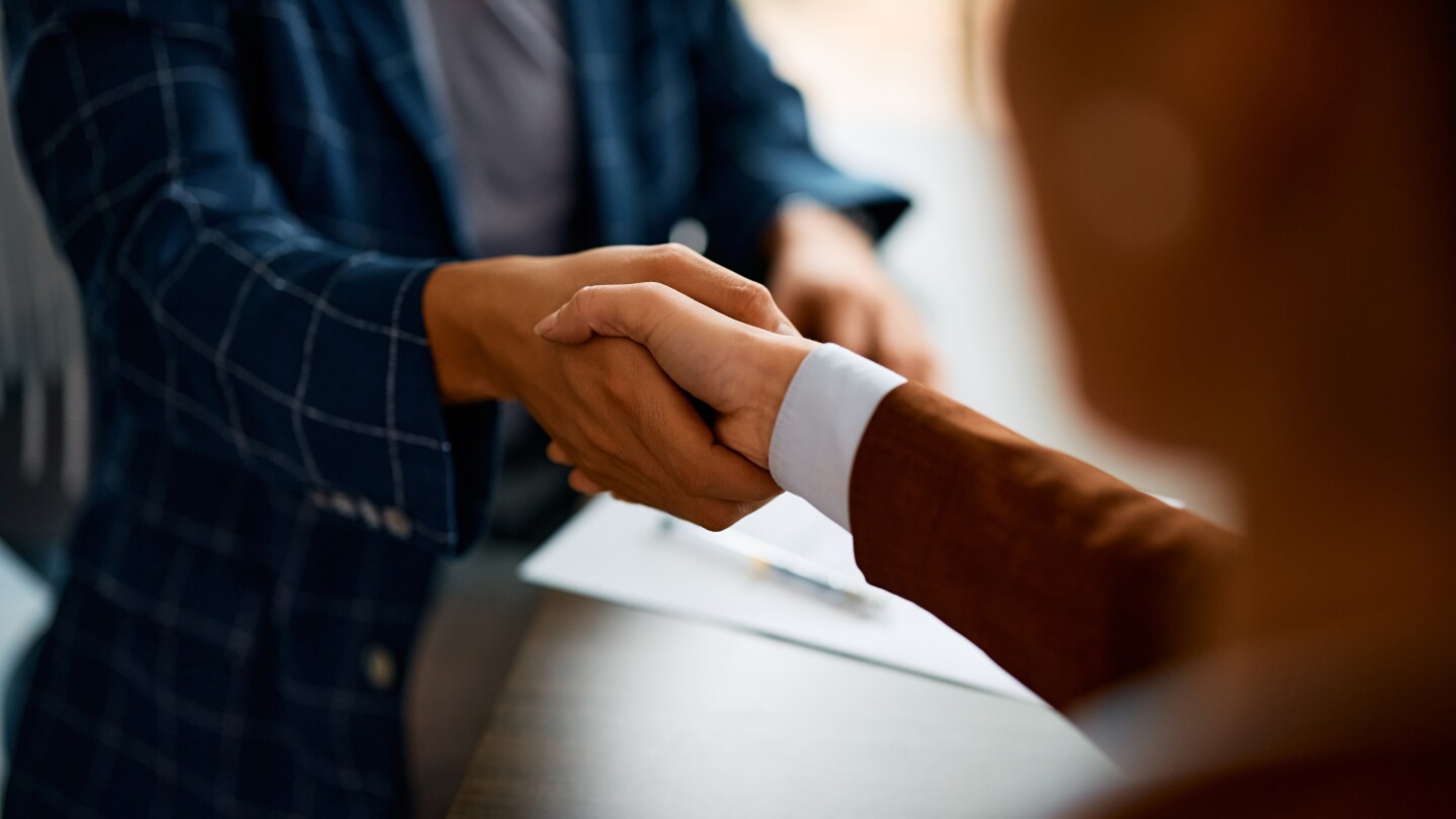 Business partners shaking hands after closing a deal