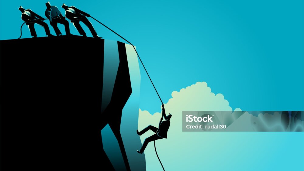 Businessmen helping their friend climbing the rock, teamwork, partnership in business concept