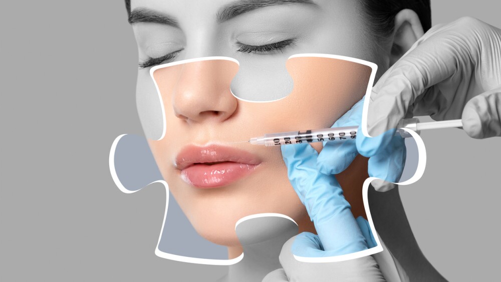 Cosmetologist does injections on the lips and on the face of a beautiful woman in a beauty salon. Cosmetology concept.