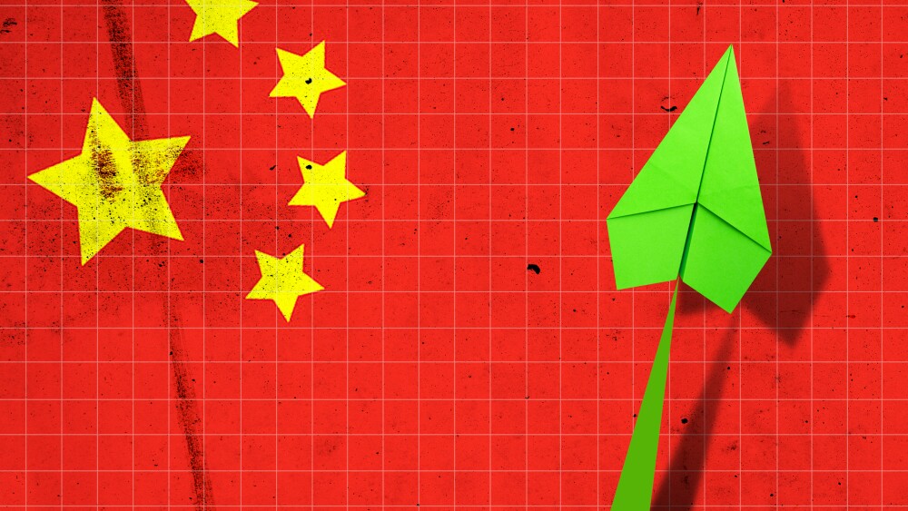 Upward arrow on the background of the flag of China. Paper plane. Economic recovery. Copy space. Business. Background.