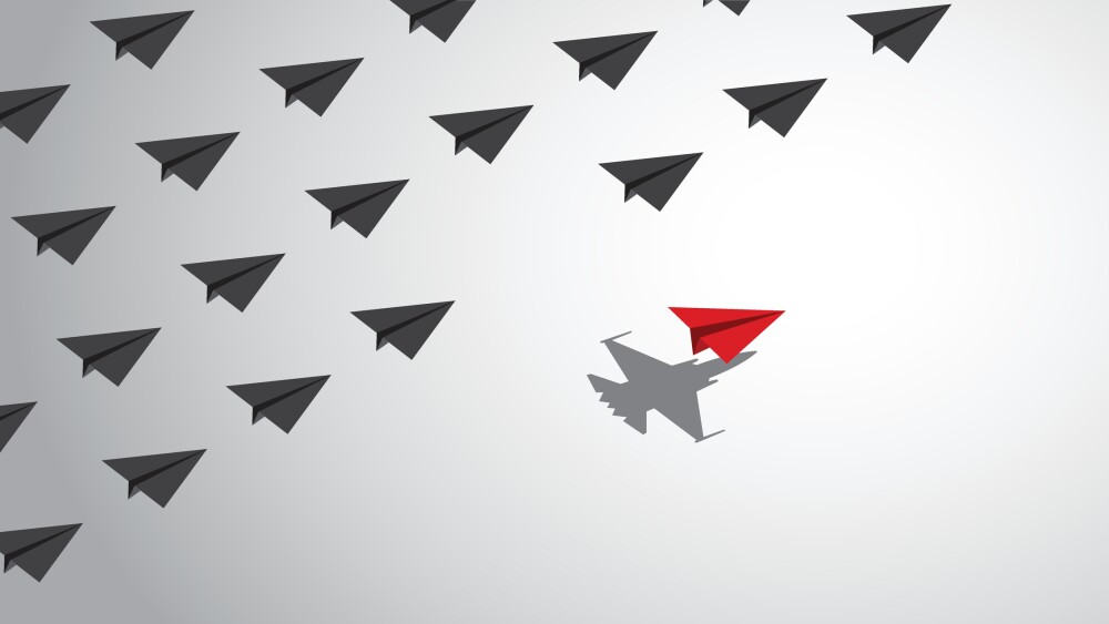 A red paper airplane with a fighter jet shadow changes course from a group of other paper airplanes, a concept of different business and social behaviors. Vector illustration.