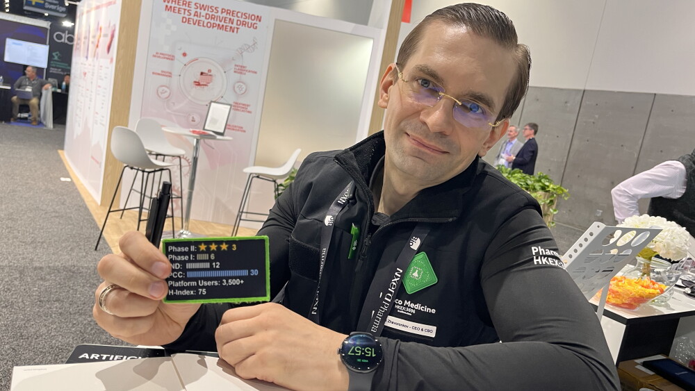 Insilico Medicine CEO Alex Zhavoronkov displays his badge that shows the progress of the therapies he has worked on at the BIO International Convention in June 2026.
