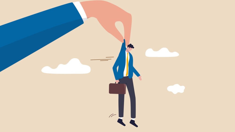 Illustration of employer’s hand holding employee who was laid off to drop him out of office