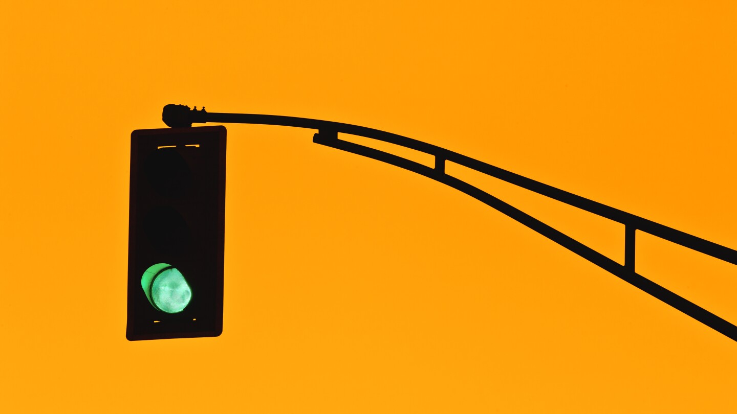 Traffic light silhouette and golden sky.