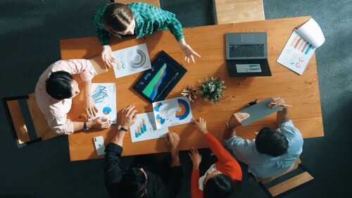 A top-down view of a business team holding a meeting