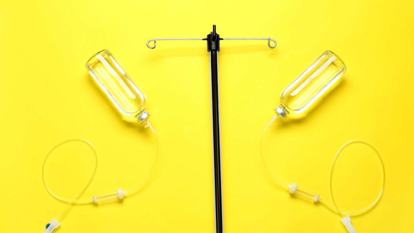 IV infusion set on yellow background, flat lay