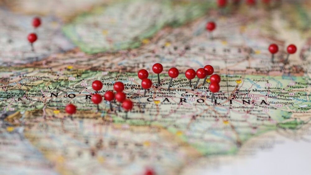 USA Map with red pins featuring the Carolinas, specifically Raleigh Durham. Could be used to showcase store locations or represent many locations.